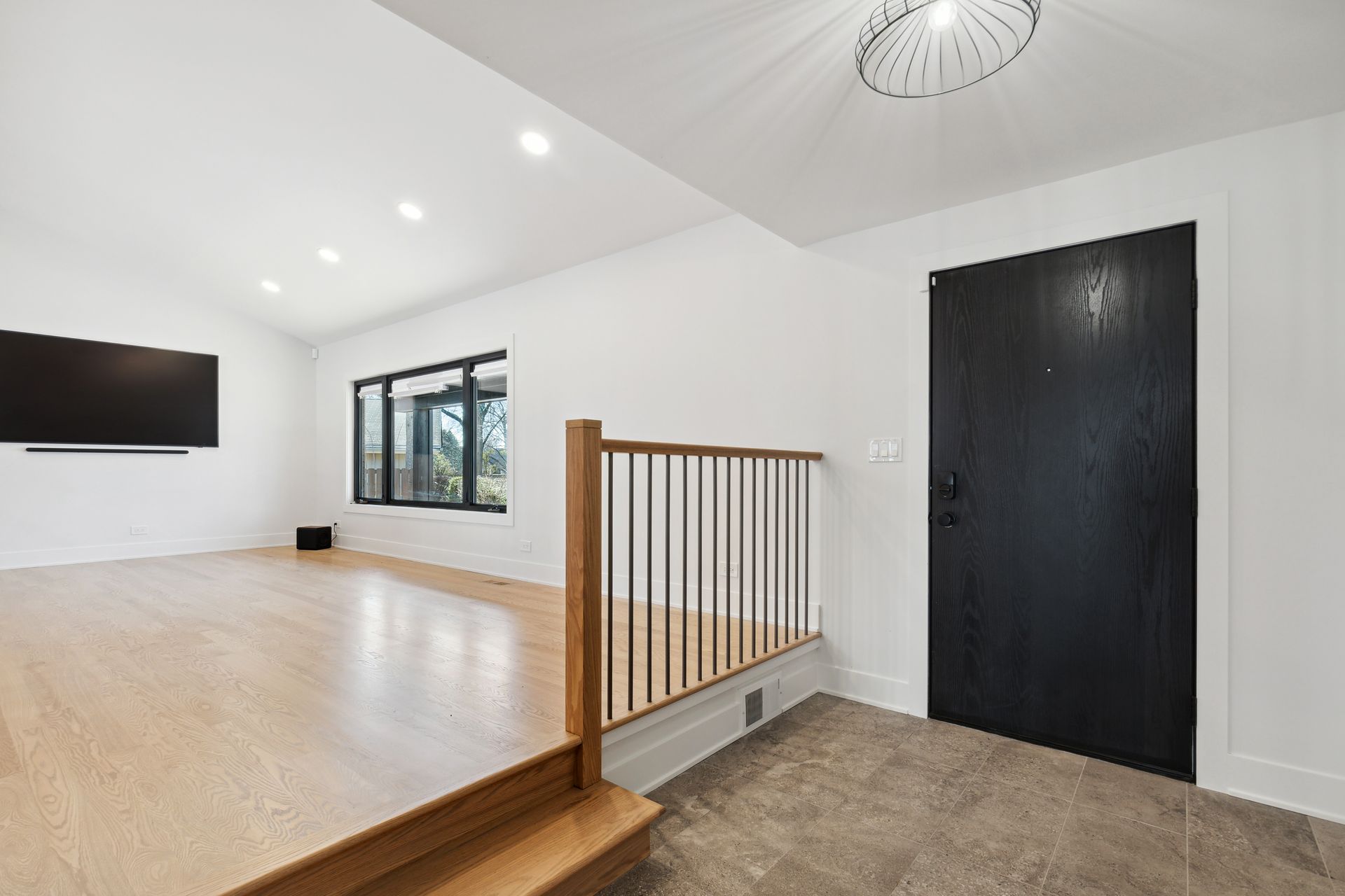 There is a black door in the middle of the room.