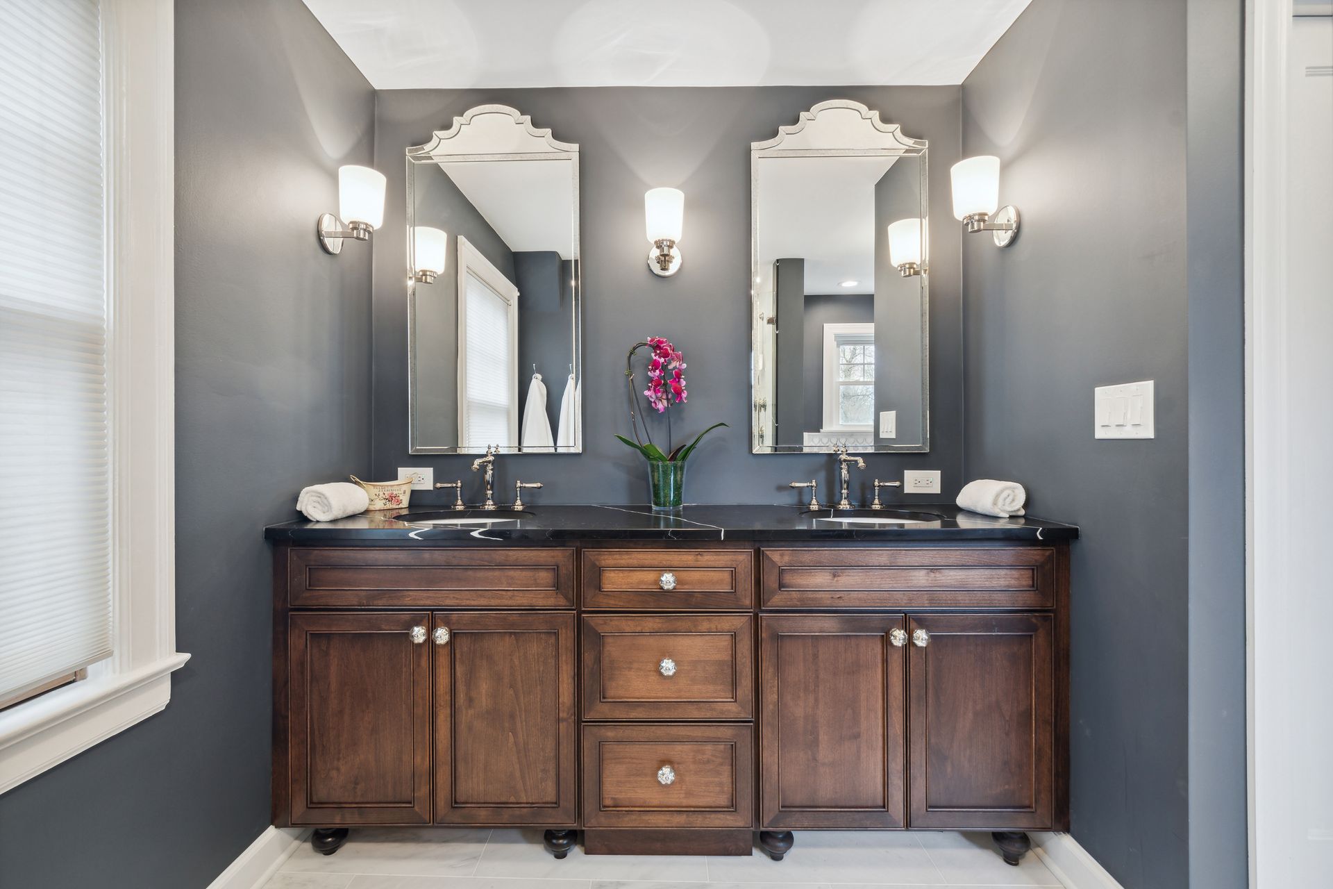 A bathroom with two sinks and two mirrors.