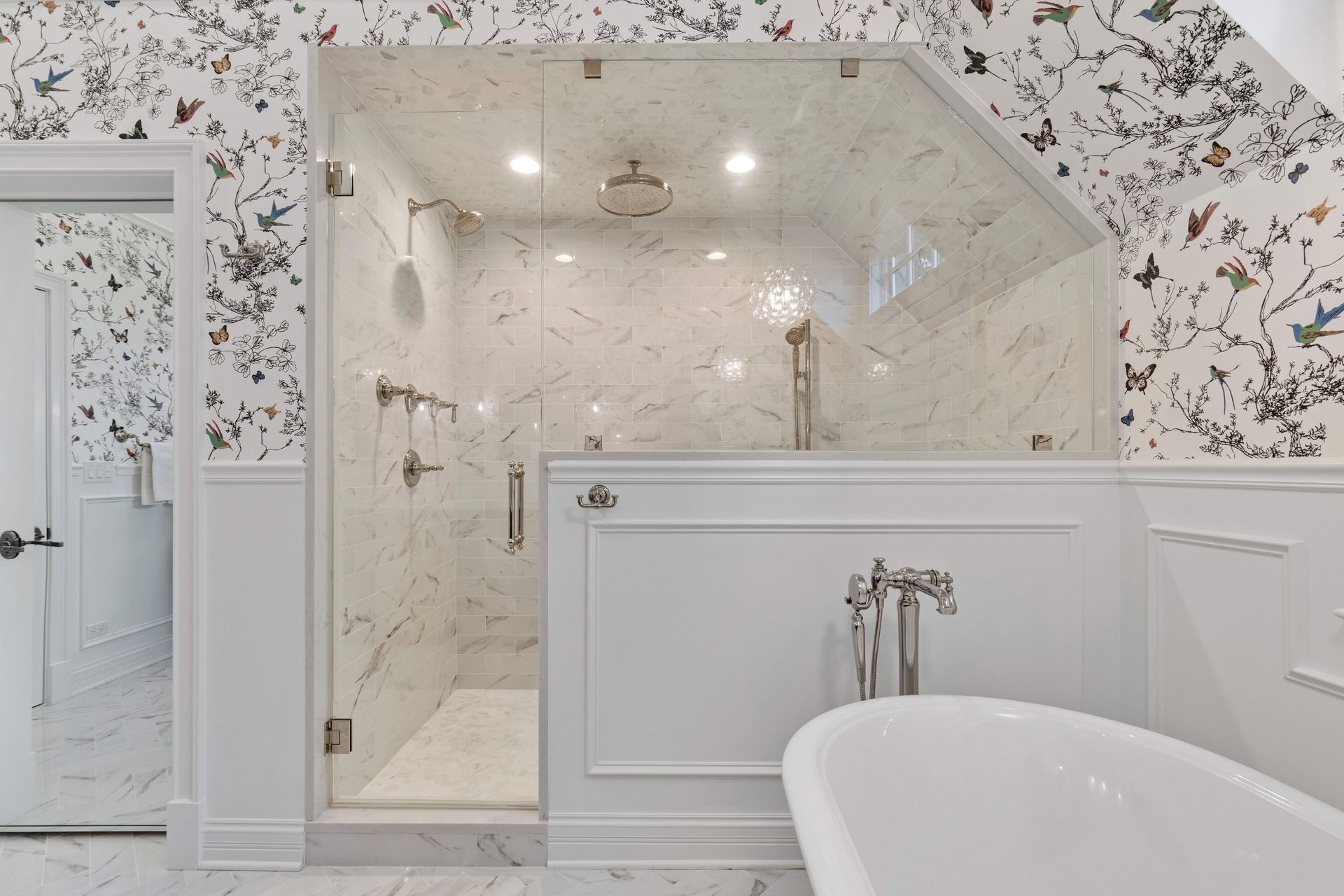 A bathroom with a walk in shower and a bathtub.