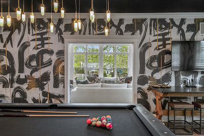 There is a pool table in the middle of the room.