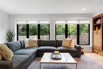 A living room with a large sectional couch and a coffee table.