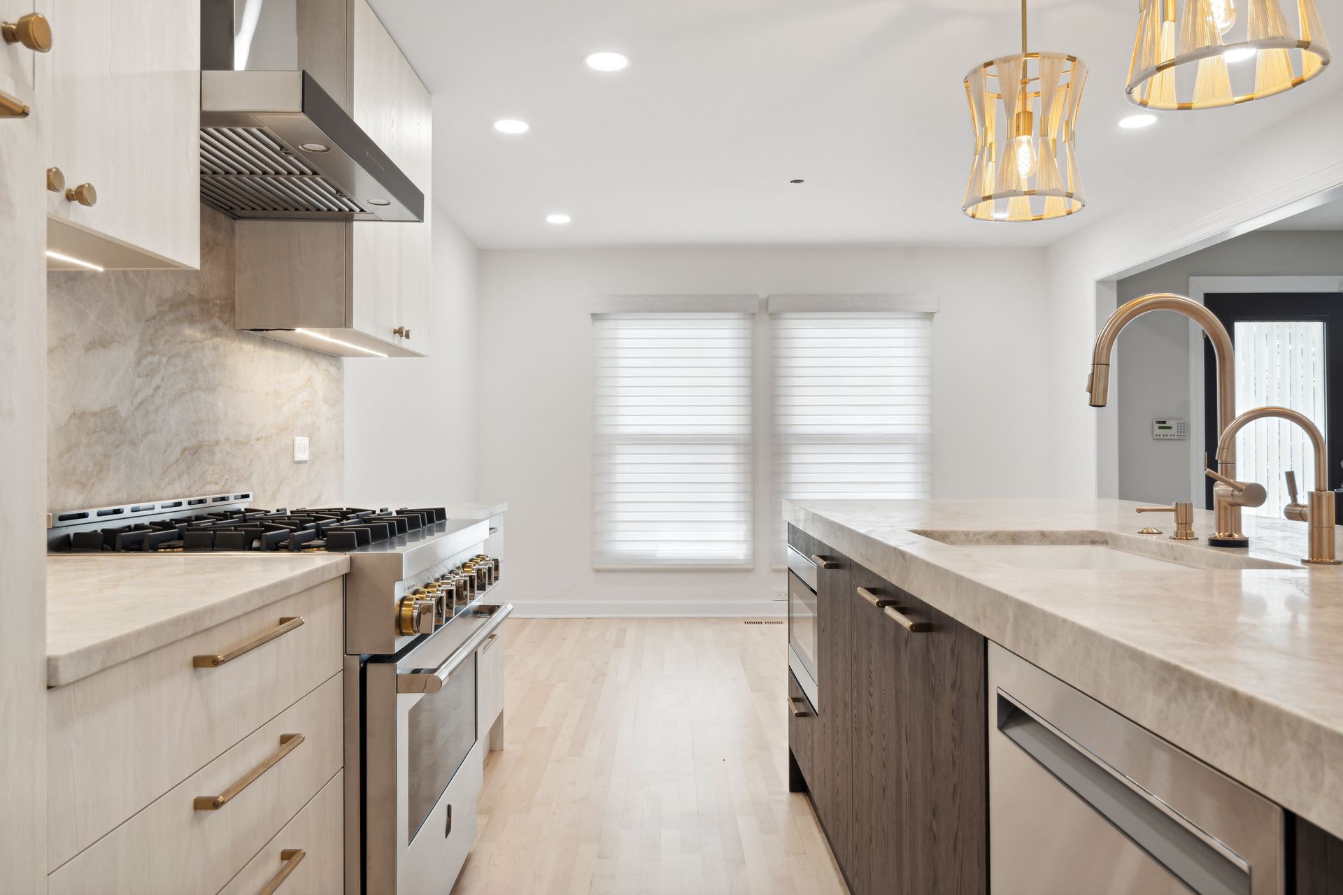 A kitchen with a stove , sink , and dishwasher.