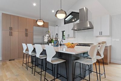 A kitchen with a large island and stools.