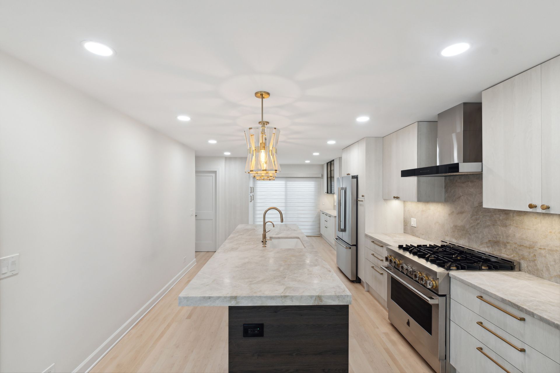A kitchen with white cabinets and stainless steel appliances