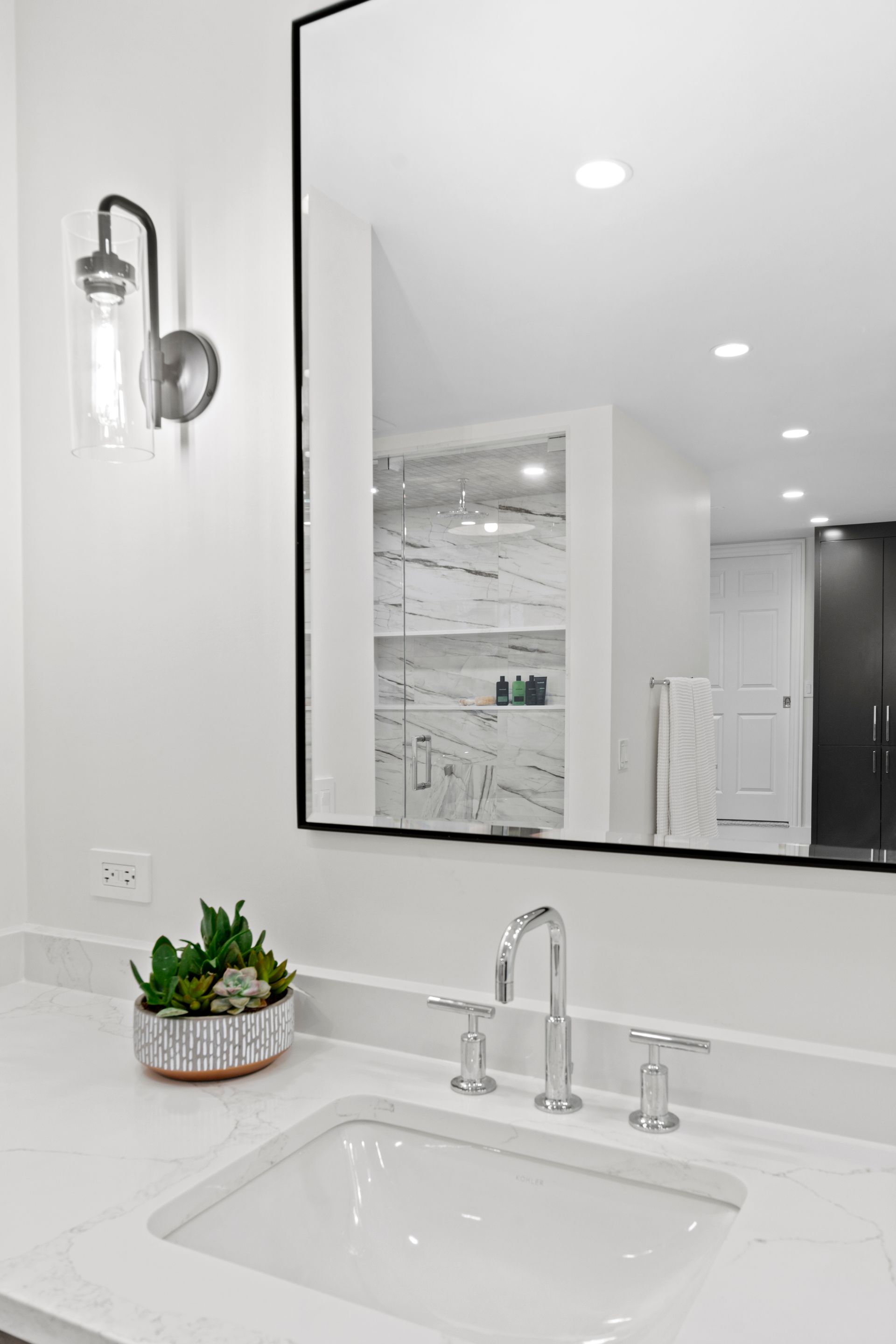 A bathroom sink with a large mirror above it.