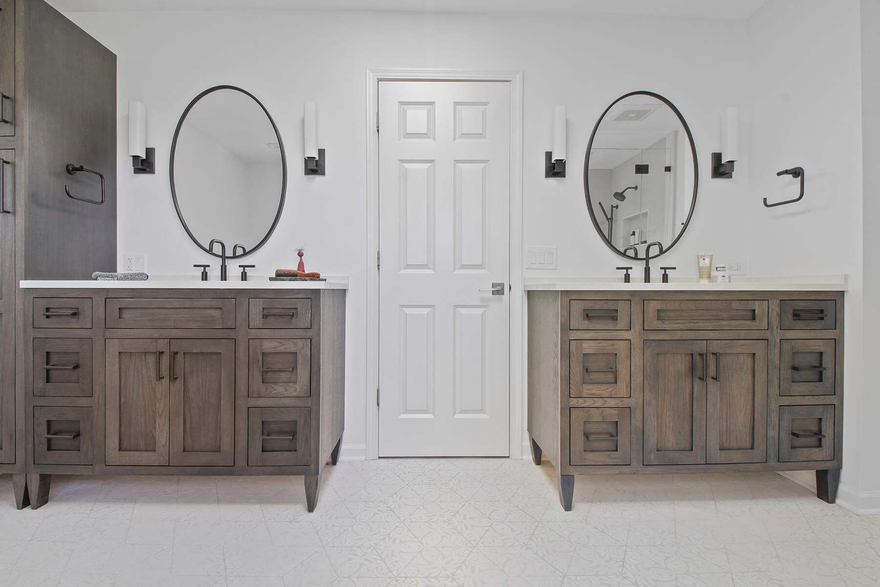 A bathroom with two sinks and two mirrors.