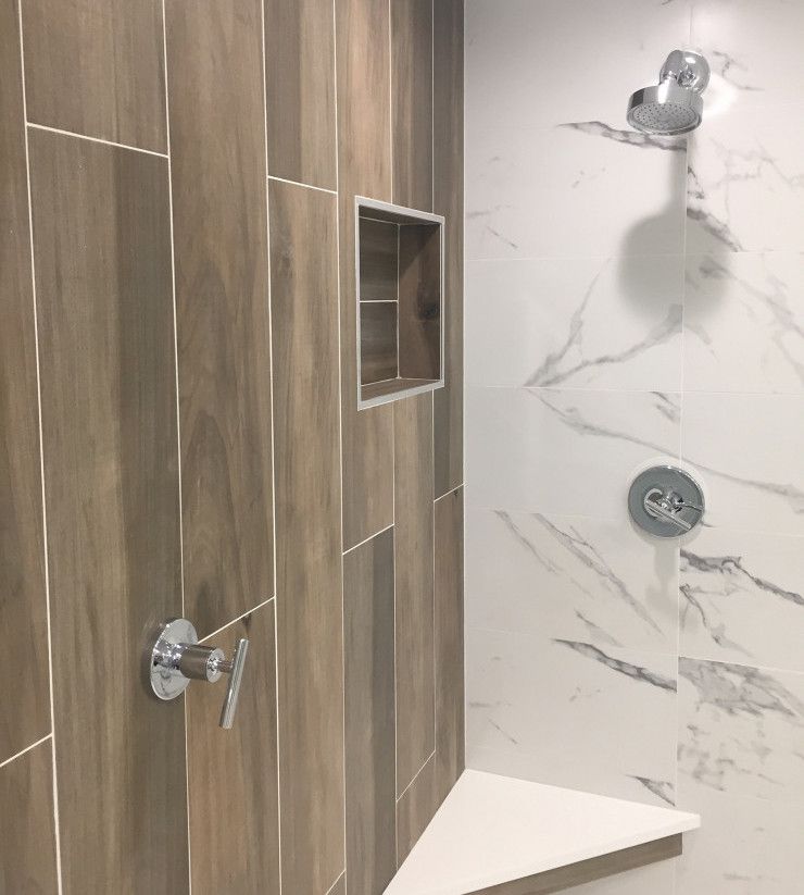 A shower with wooden tiles and marble walls