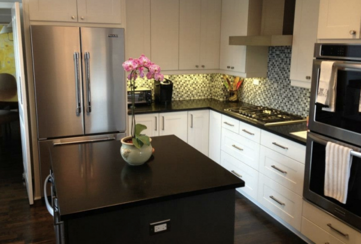 A kitchen with stainless steel appliances and white cabinets