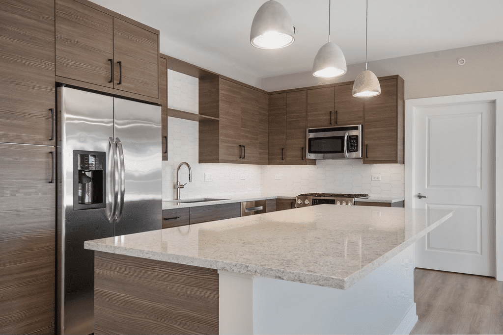 A kitchen with stainless steel appliances and granite counter tops.
