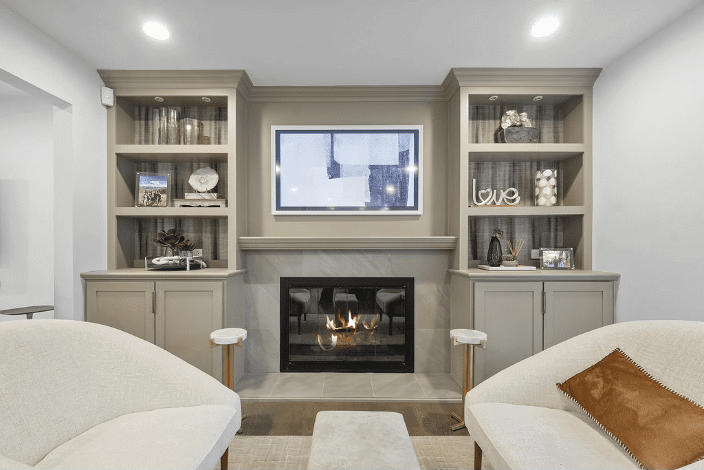 A living room with a fireplace and a flat screen tv