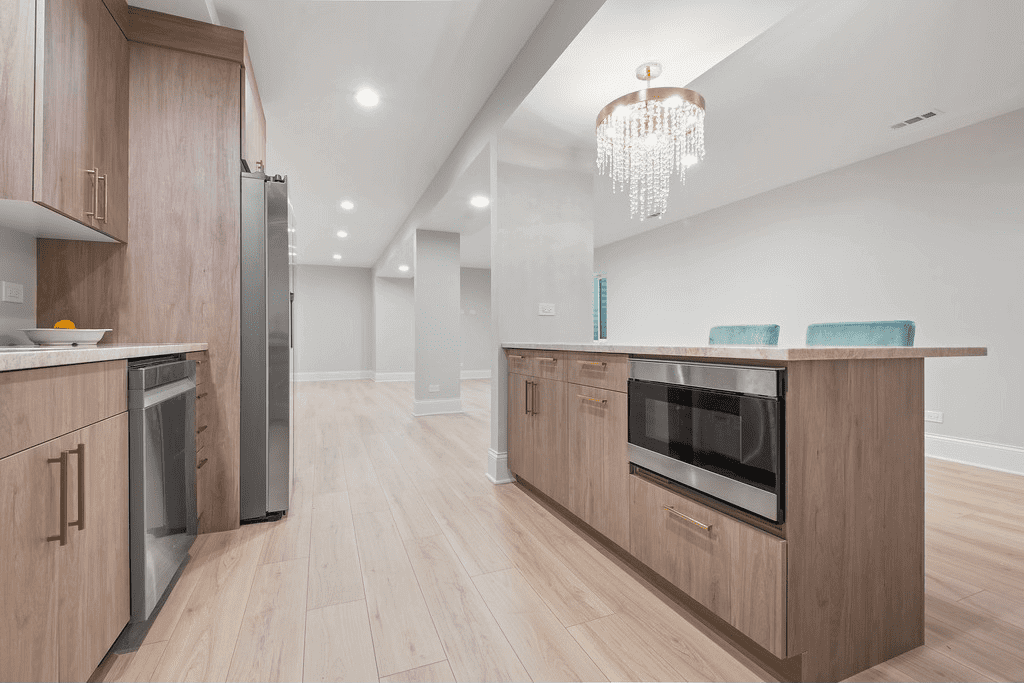 A kitchen with wooden cabinets , stainless steel appliances , and a large island.
