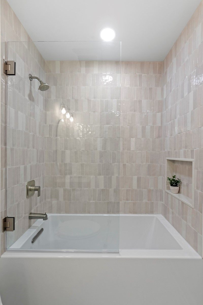 A bathroom with a bathtub and a shower.