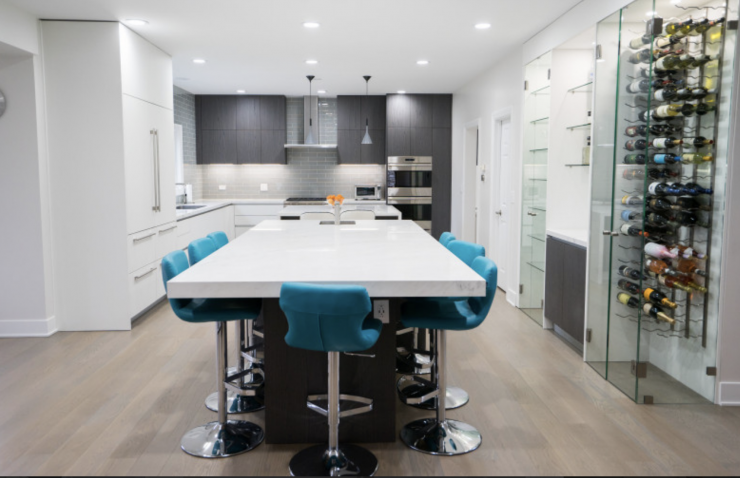 A kitchen with a large island and stools