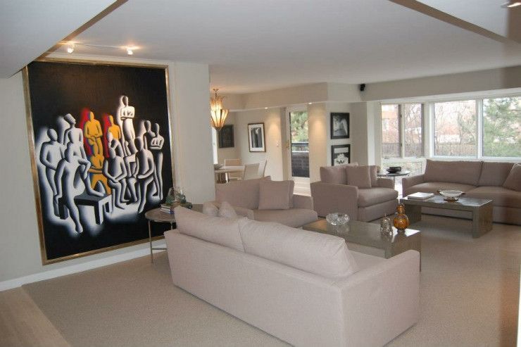 A living room with a large painting on the wall
