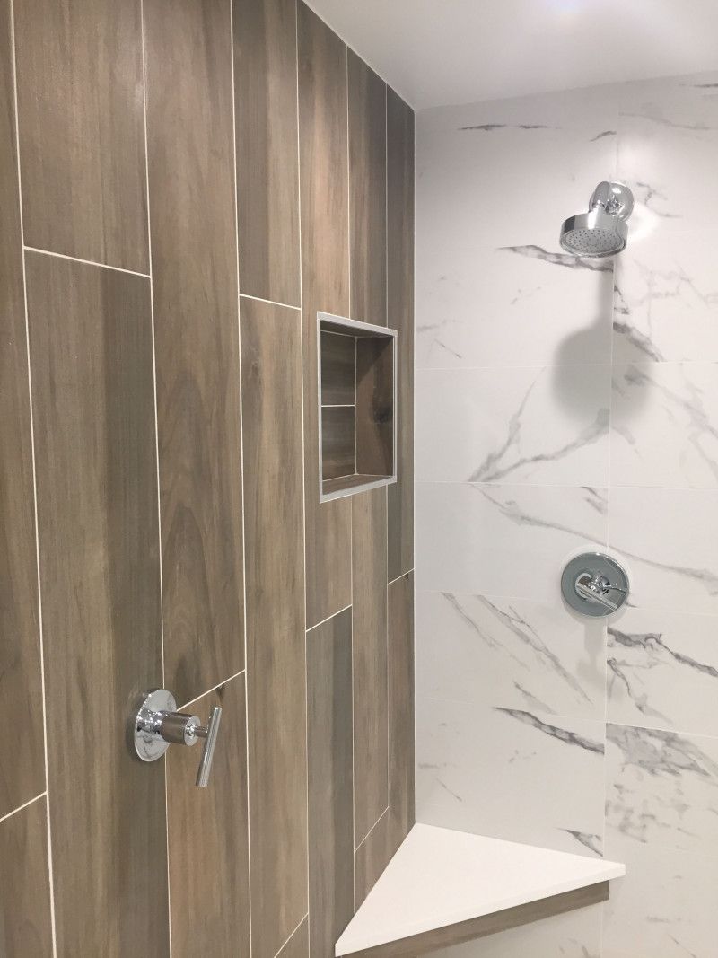 A shower with wooden tiles and marble walls