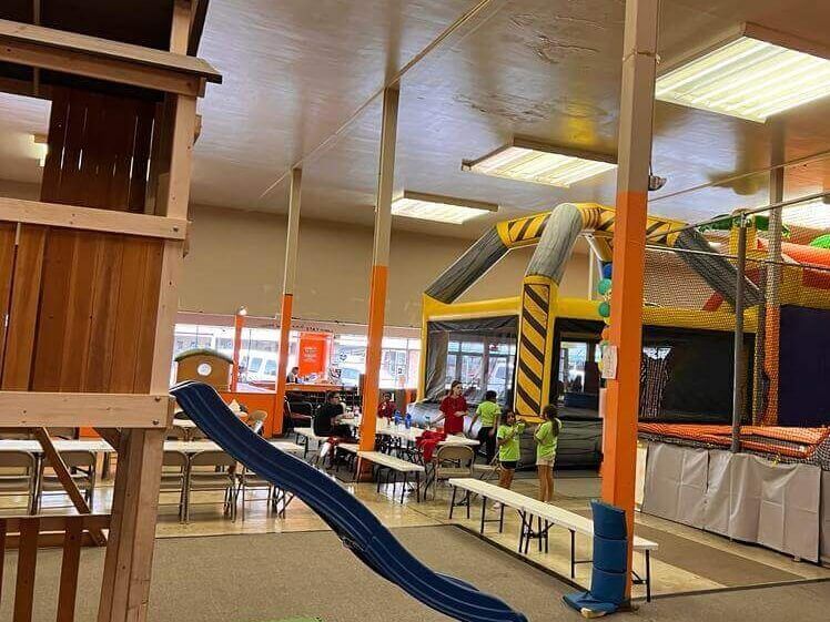 A large room with a slide and a bouncy house