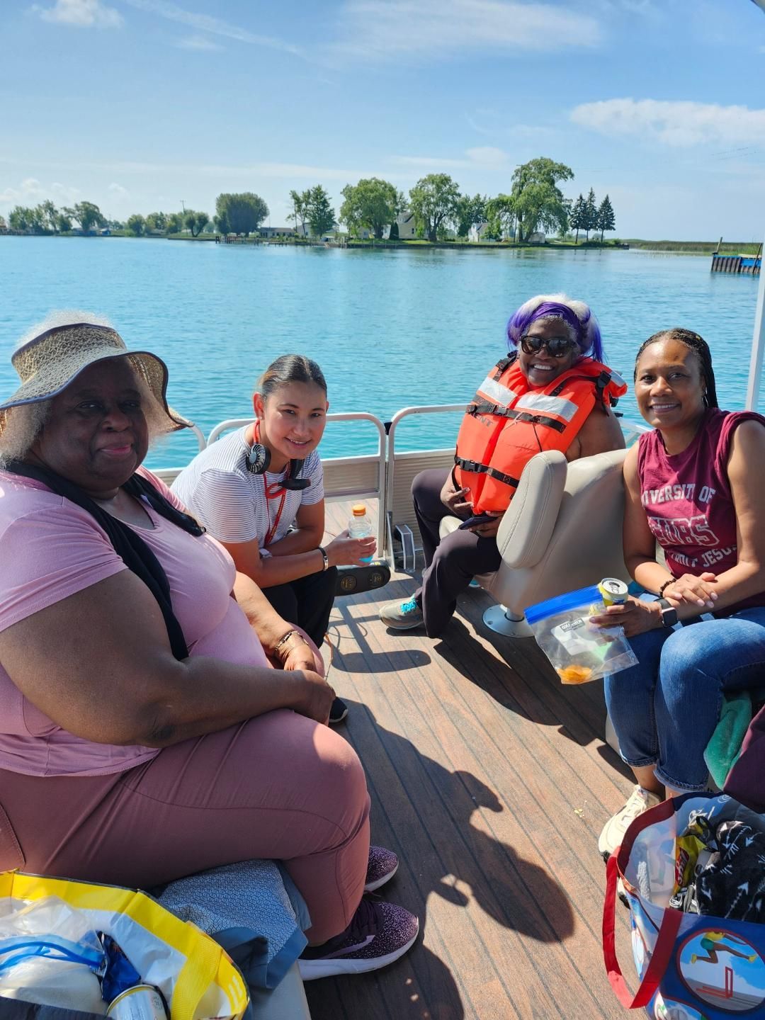 Four people on a boat, enjoying a sunny day on the water.