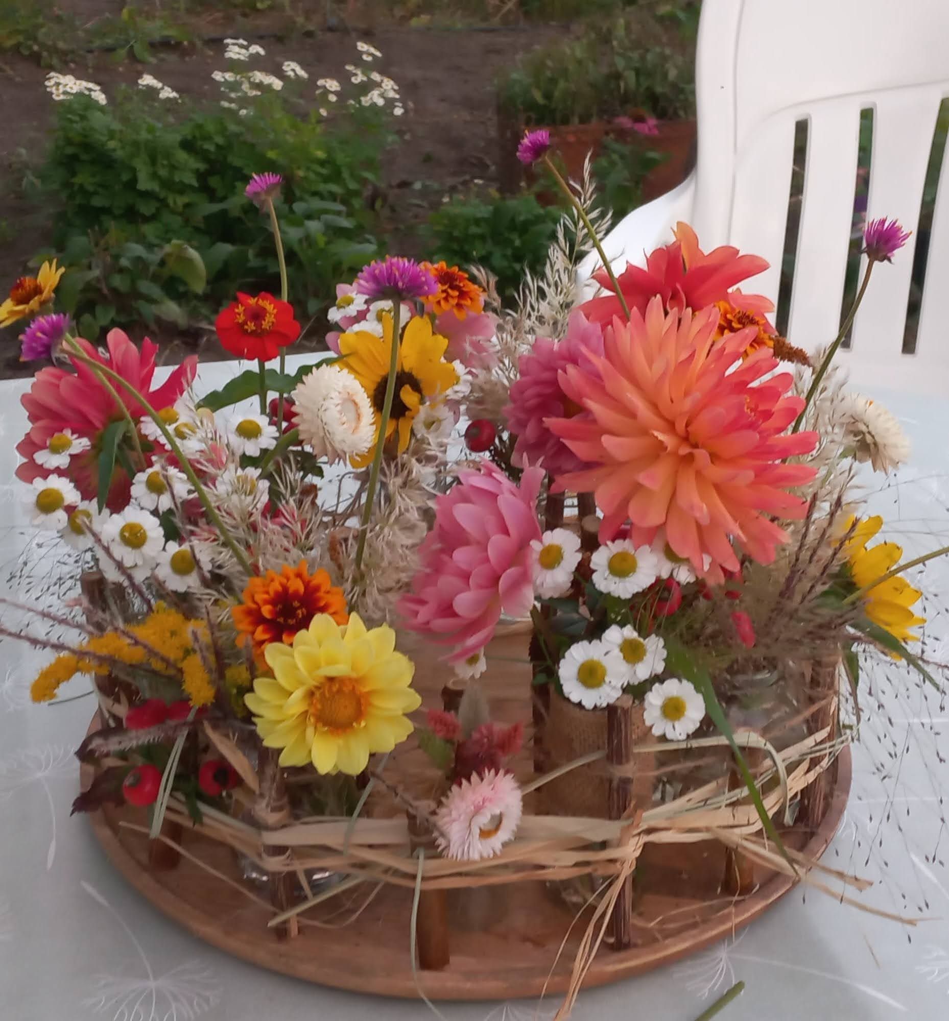 plateau met kleine vaasjes gevuld met plukbloemen