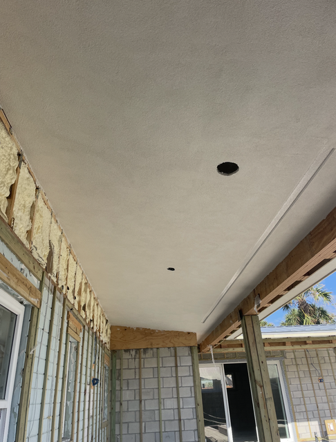 Partially finished porch ceiling with exposed walls and a hanging light opening