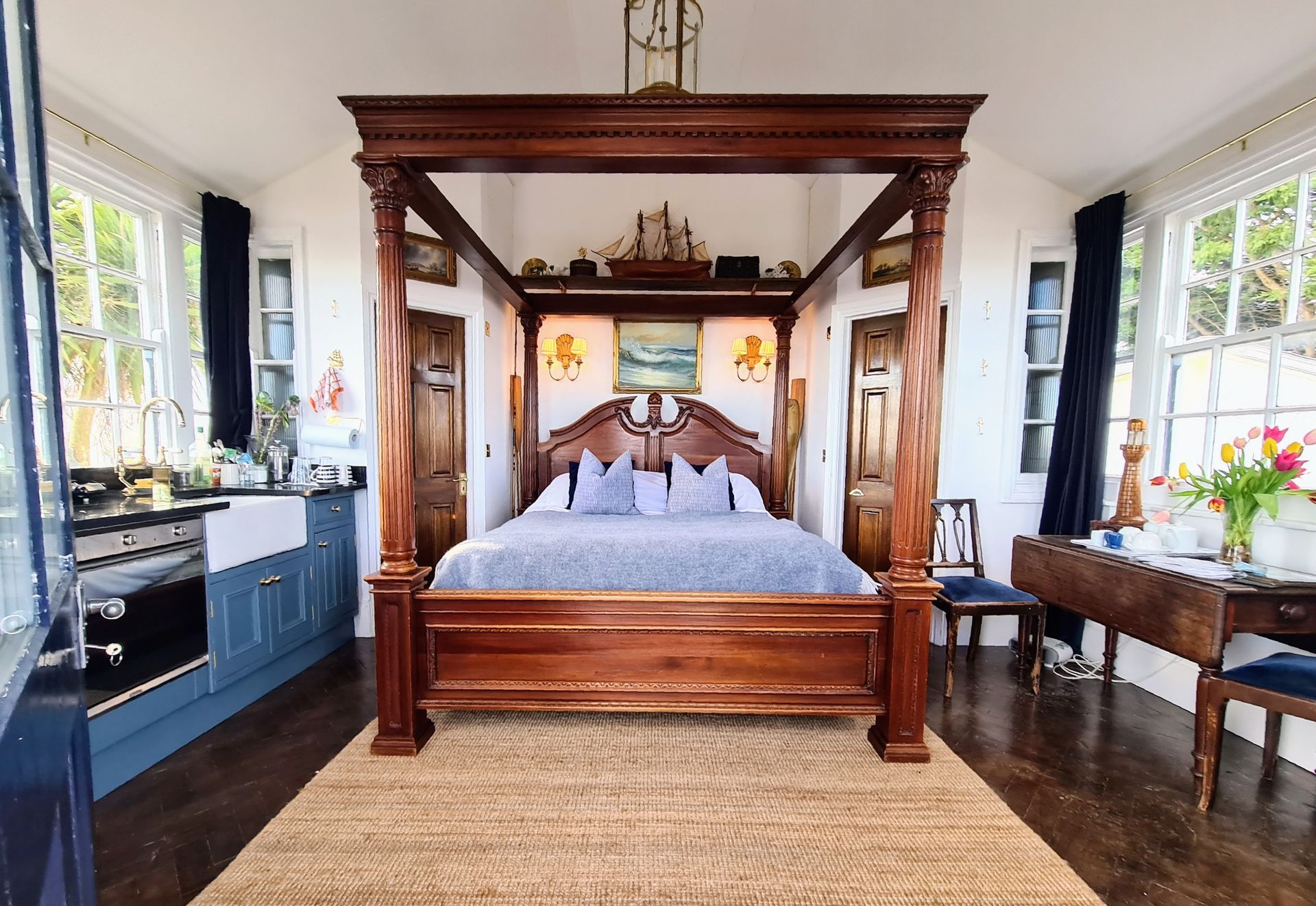 Inside the lodge at the West Usk Lighthouse, showing the kitchen and super-king size four-poster bed.
