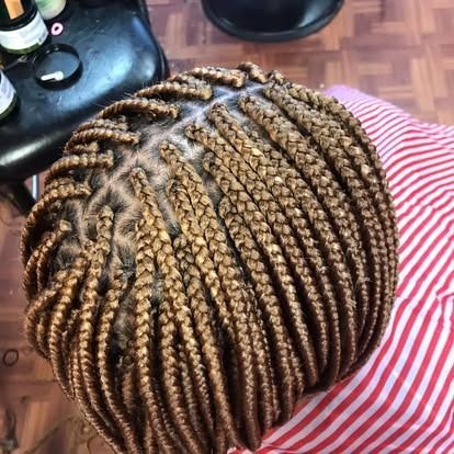 Close-up of neatly braided hair with brown highlights, viewed from above.