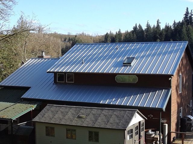 A large home building with a sloped metal roof