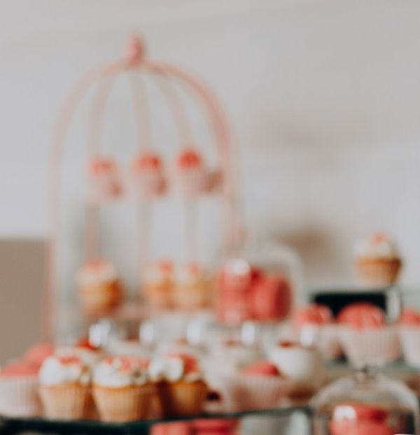 A table topped with cupcakes and cake pops.