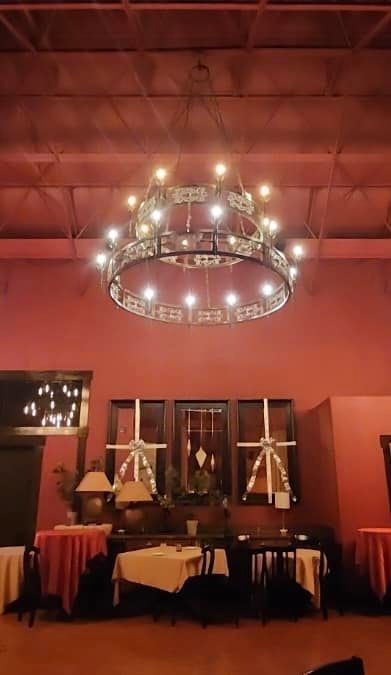 A large chandelier is hanging from the ceiling of a room