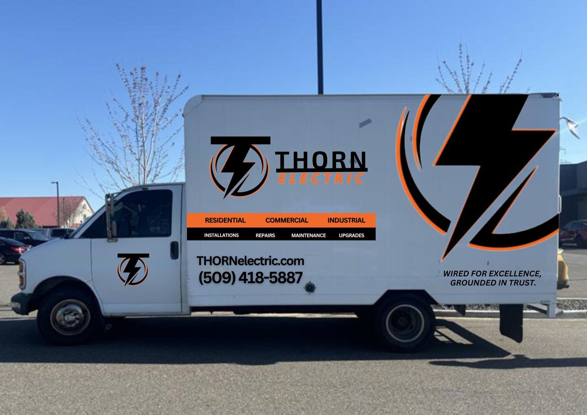 A white thorn truck is parked in a parking lot