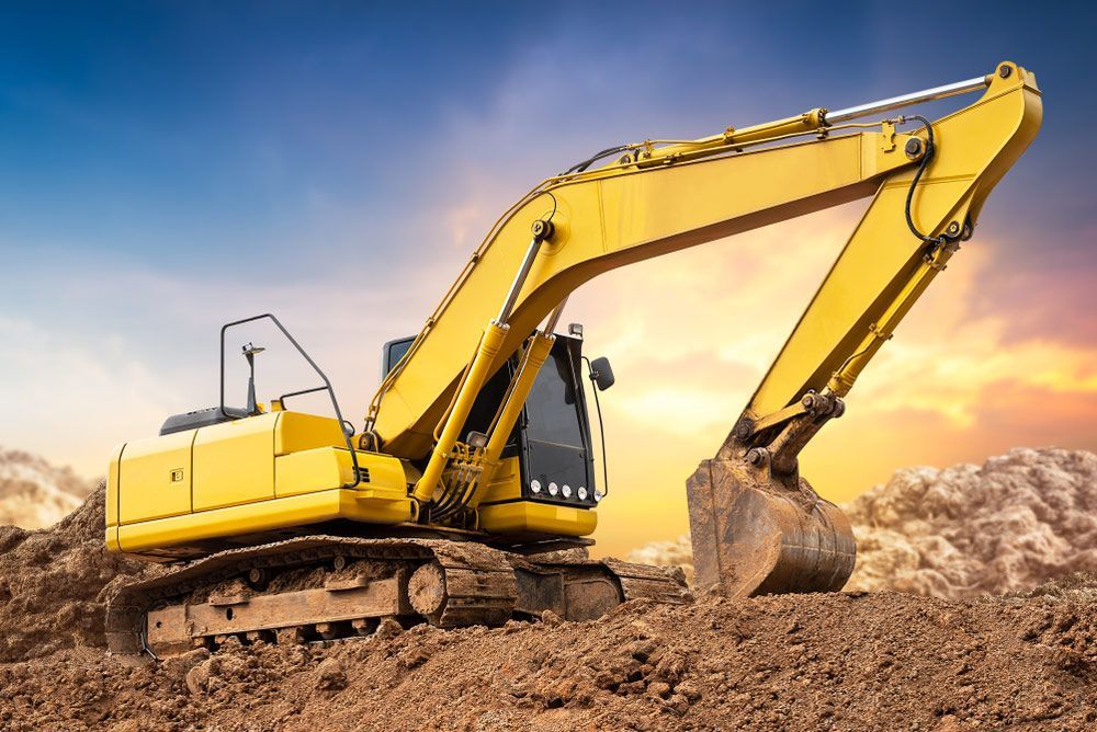 A Yellow Excavator Is Digging In The Dirt At A Construction Site — JJ's Excavator & Tipper Hire in Murgon, QLD