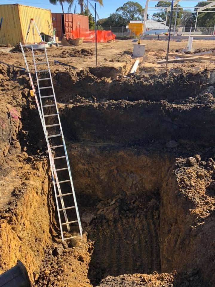 A Ladder Is Going Up Into A Hole In The Ground — JJ's Excavator & Tipper Hire in Kingaroy, QLD