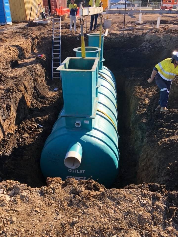 A Construction Site With A Lot Of Dirt And A Blue Pipe In The Middle Of It — JJ's Excavator & Tipper Hire in Kingaroy, QLD