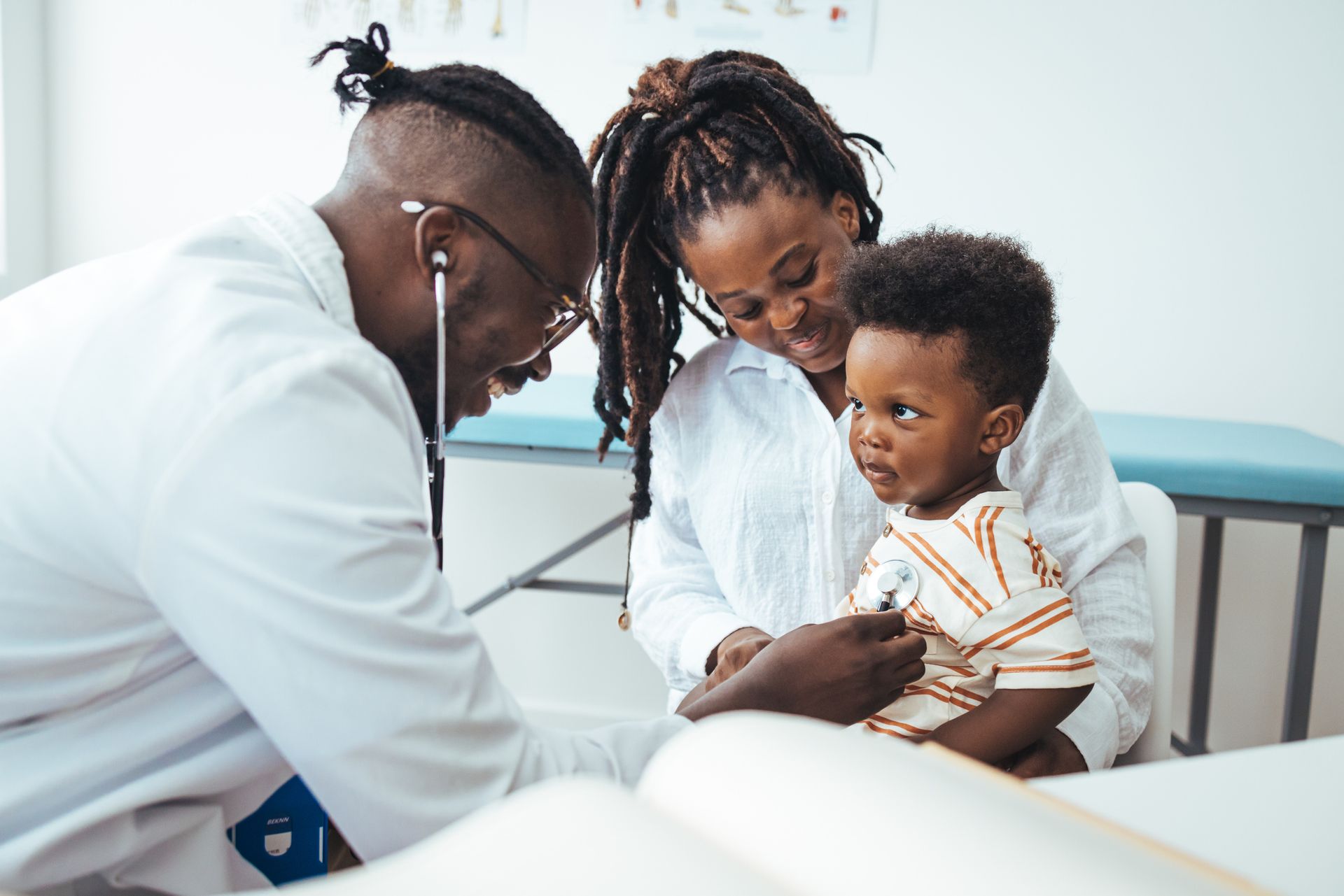 Doctor examining a child, listening to heart with a stethoscope