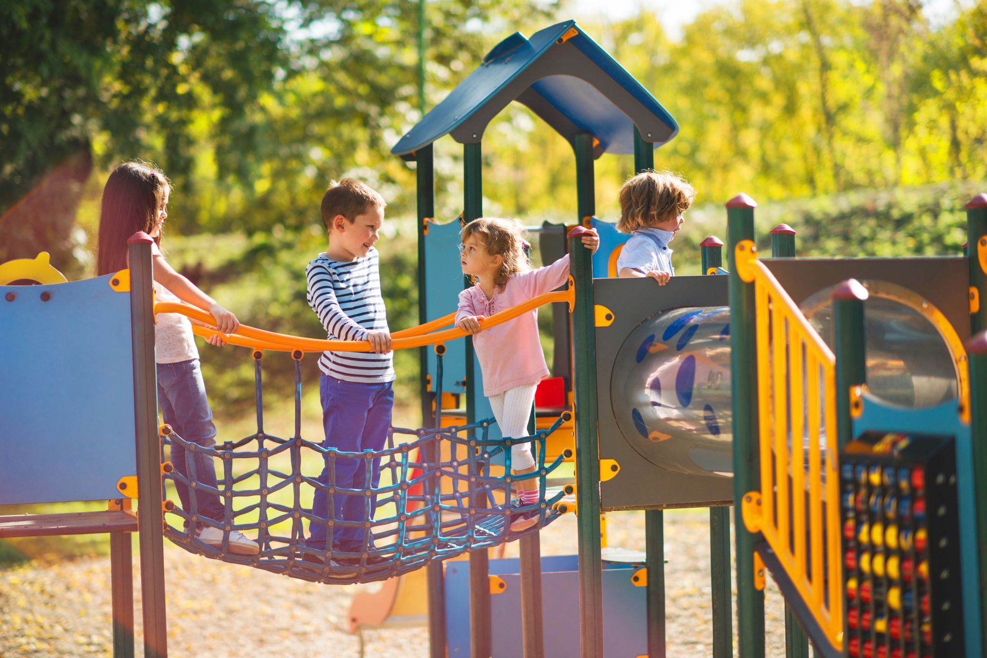 Group of children playing on a playground bridge