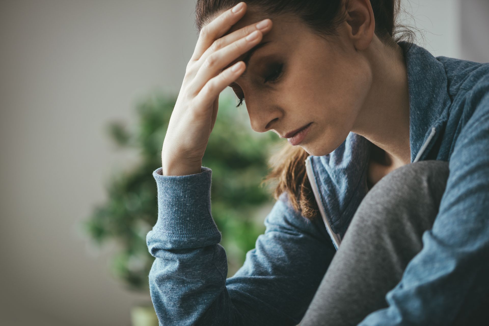 Worried woman with her head in her hand
