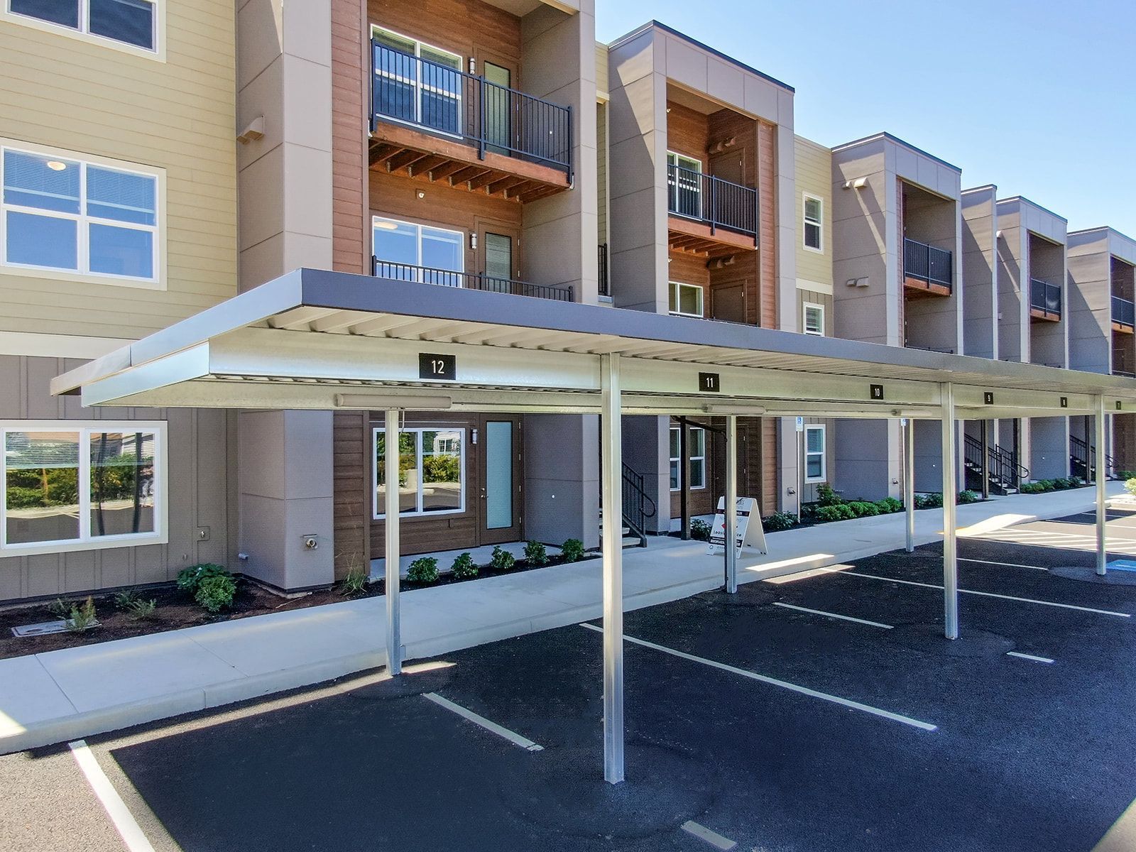 Modern apartment building with covered parking and balconies