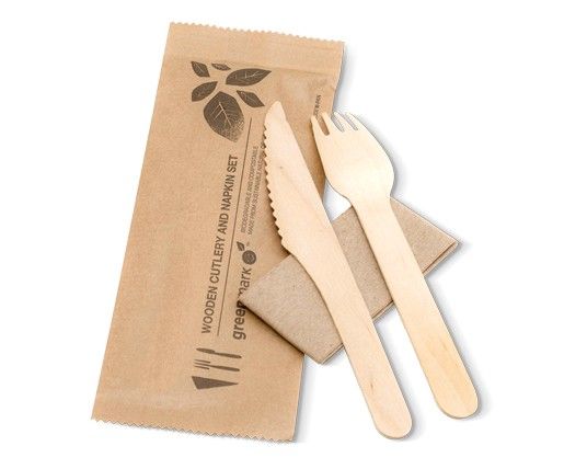 Eco-friendly paper takeout pouch with wooden fork, knife, and spoon on a white background