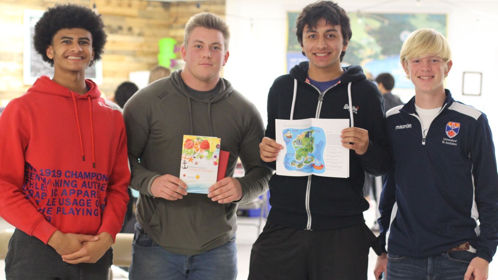 Human Rights Education & Training: A group of young men are standing next to each other holding cards and drawings.