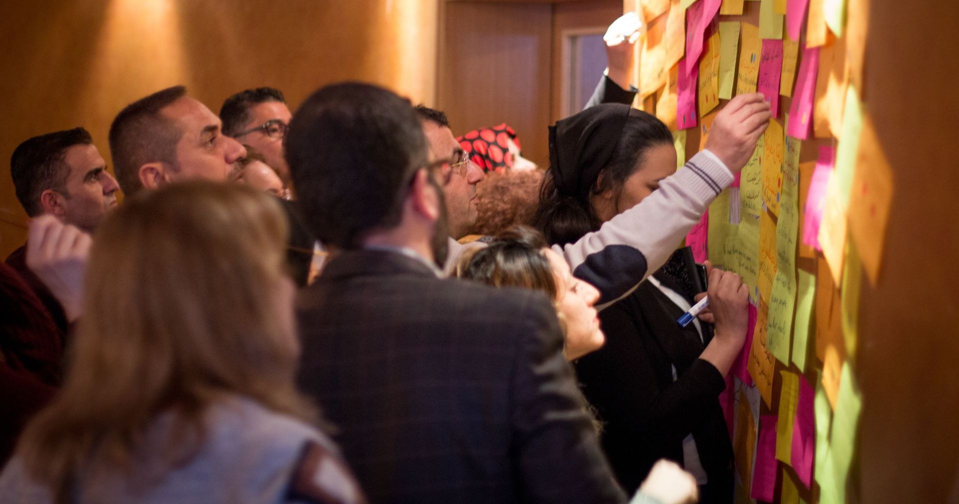 Religious Freedom Organization: A group of people are putting sticky notes on a wall.