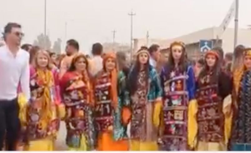 Non Profit: A group of women in traditional costumes are standing next to each other in a crowd.