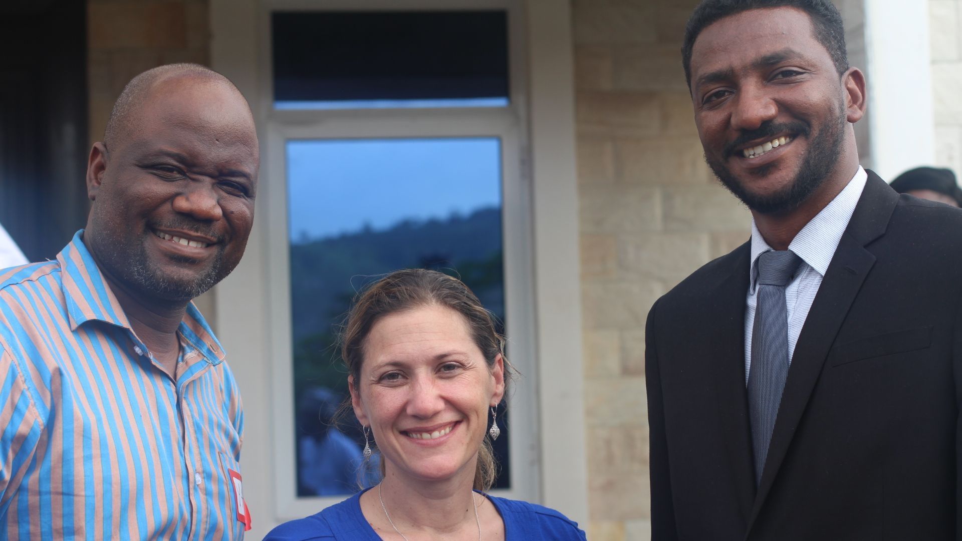Non Profit Organization for Human Rights: A man in a suit and tie is standing next to a woman in a blue shirt.