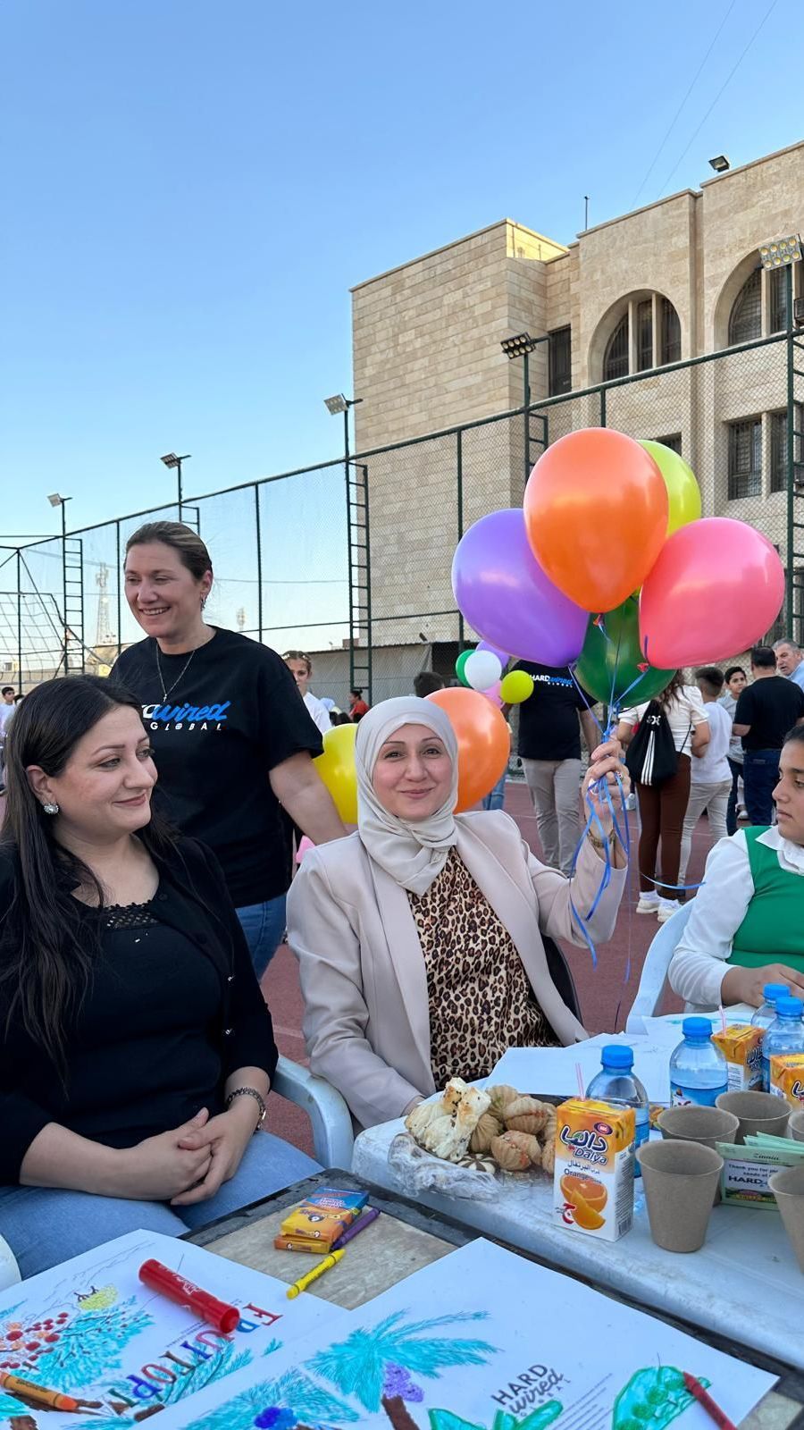 Human Rights Education & Training: A group of people are sitting at a table with balloons.