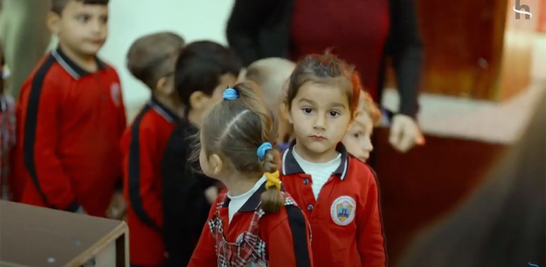 civil society & religious freedom: A group of children are standing next to each other in a classroom.
