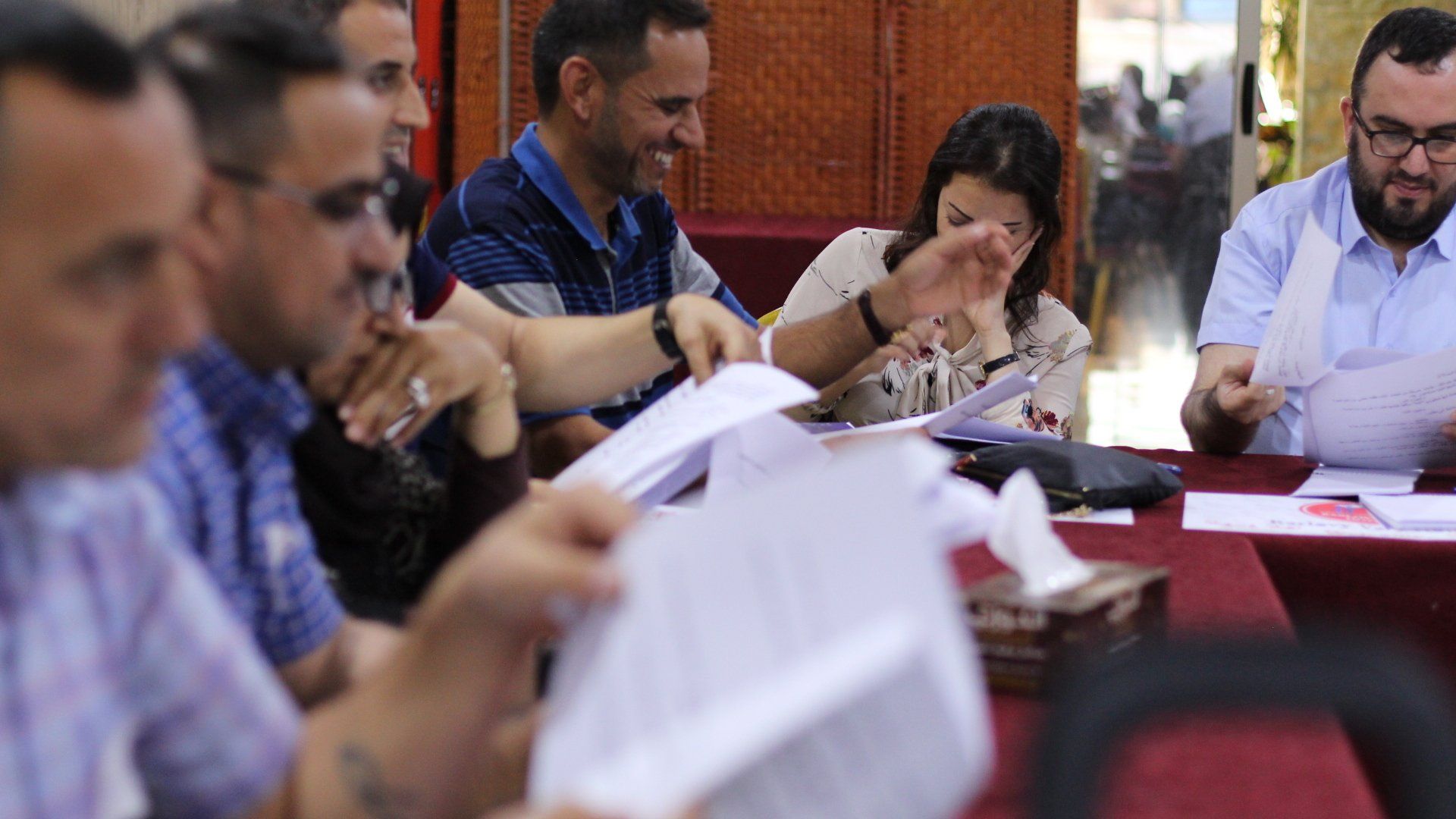 Human Rights Programs: A group of people are sitting around a table looking at papers