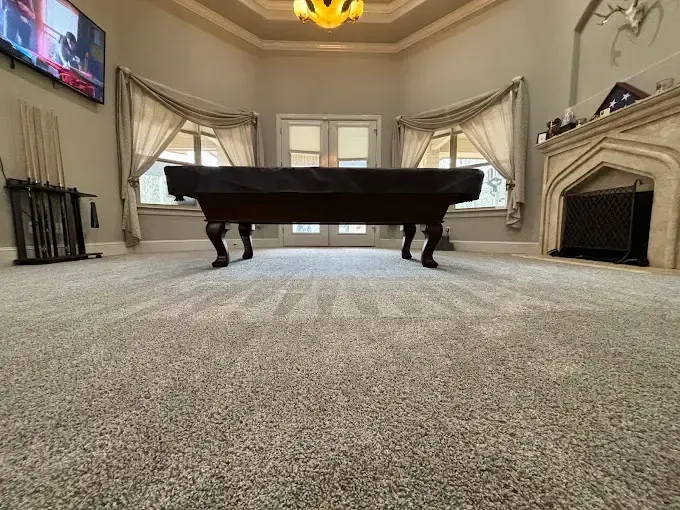 MB Carpet Cleaning- A pool table is sitting in the middle of a living room.