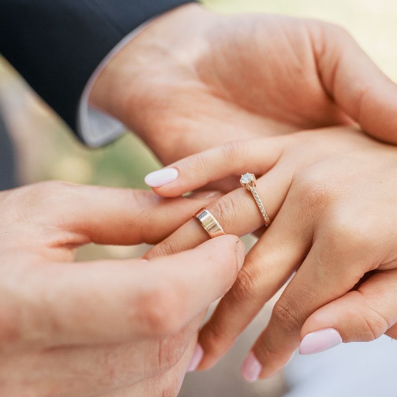somone putting a ring on a woman