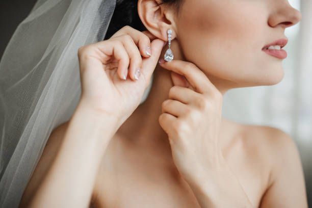 woman putting in earring