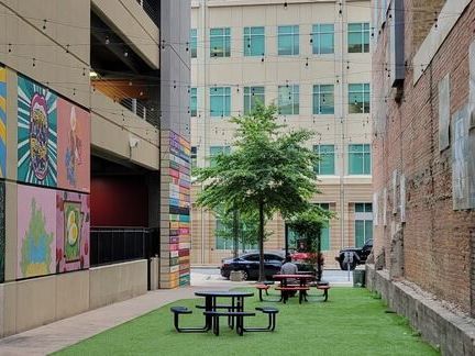 A narrow alleyway with a picnic table in the middle of it.