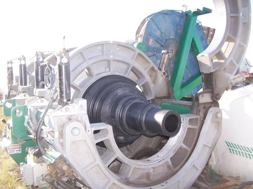 Industrial machine with large circular housing and a central black spindle in a workshop