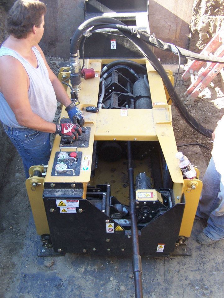 Person operating a yellow industrial machine at a construction site